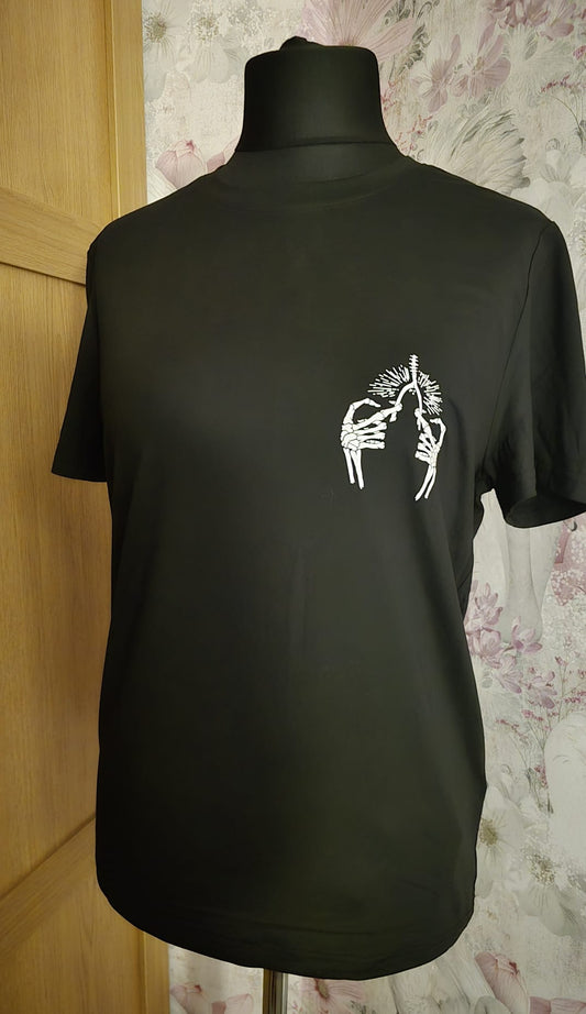 Black t-shirt with a white graphic design on a mannequin against a floral wallpapered wall.