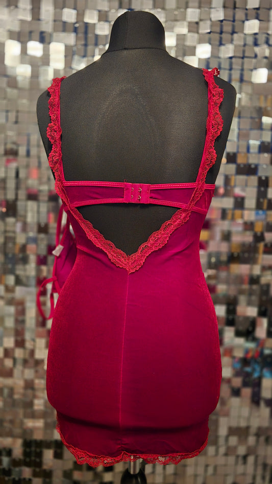 Red lace dress on a mannequin against a mosaic tile background
