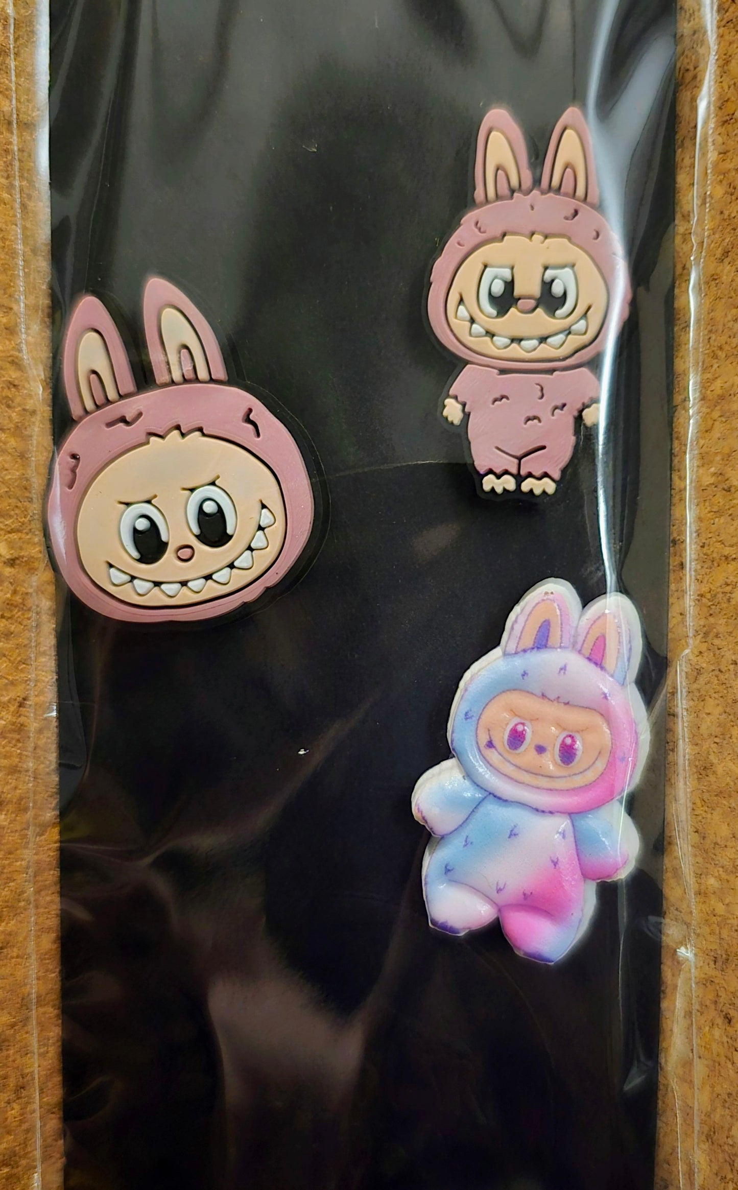 Three cartoon rabbit figurines on a black background